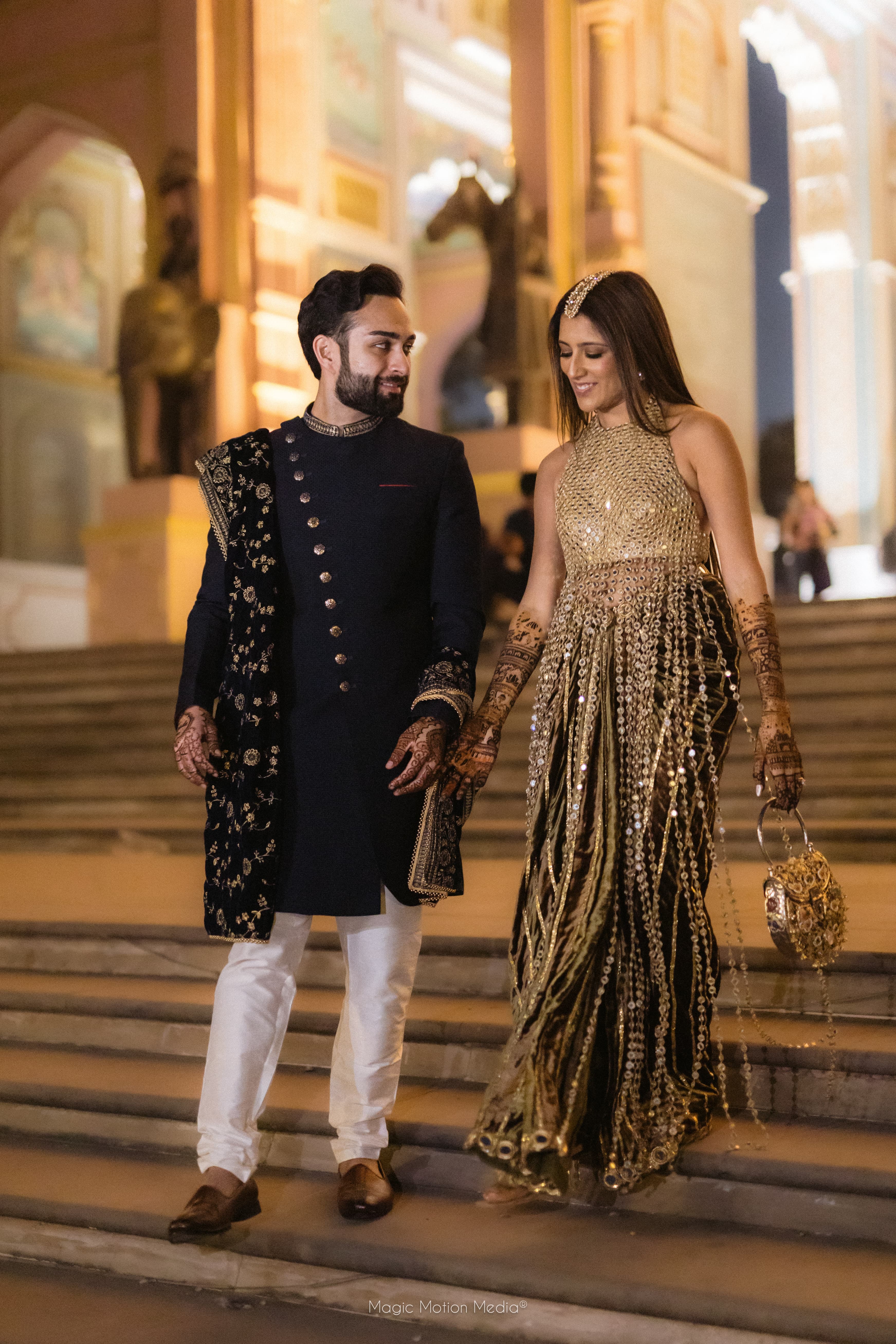 Couple in evening occasion wear on grand stairs